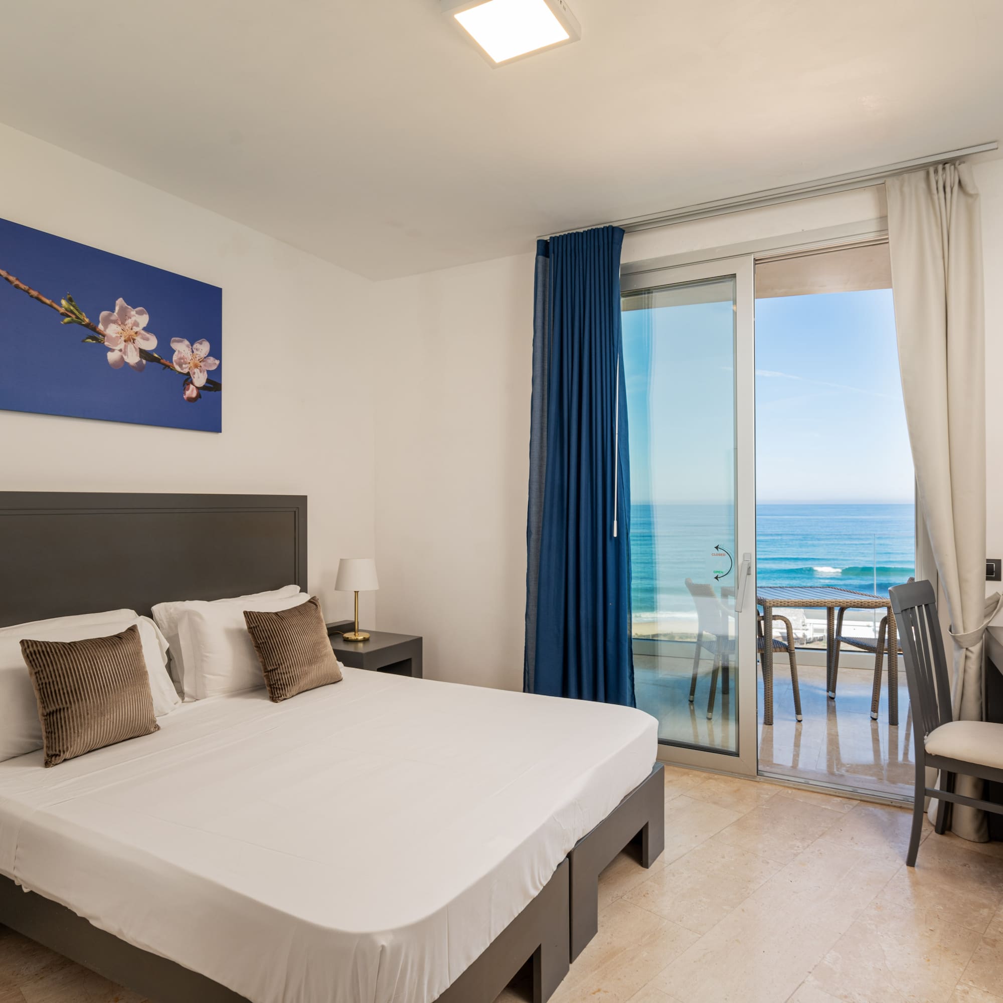 a bedroom with a glass door and a bed