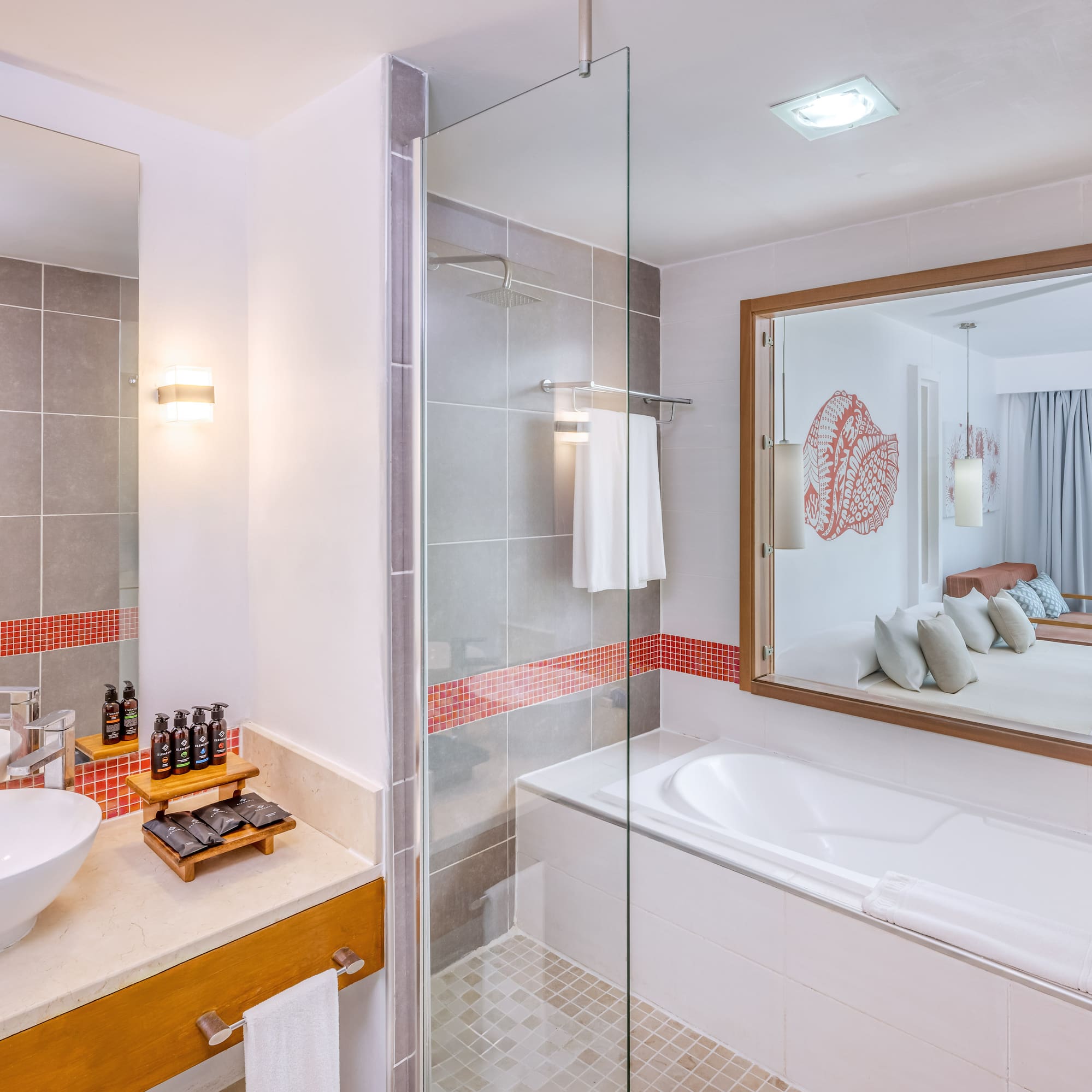 a bathroom with a glass shower and a sink