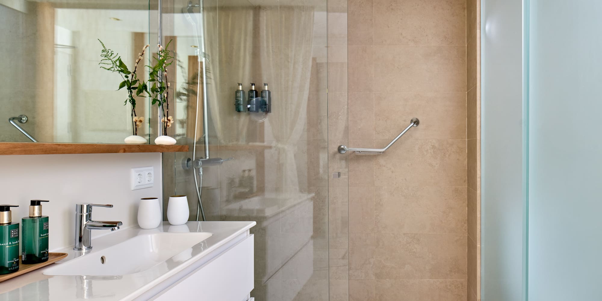 a bathroom with a glass shower door