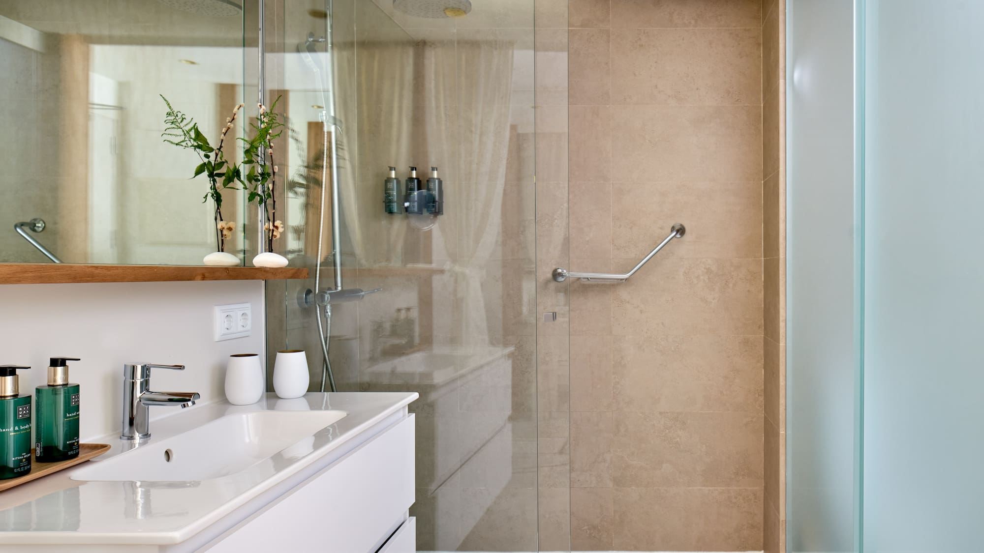 a bathroom with a glass shower door