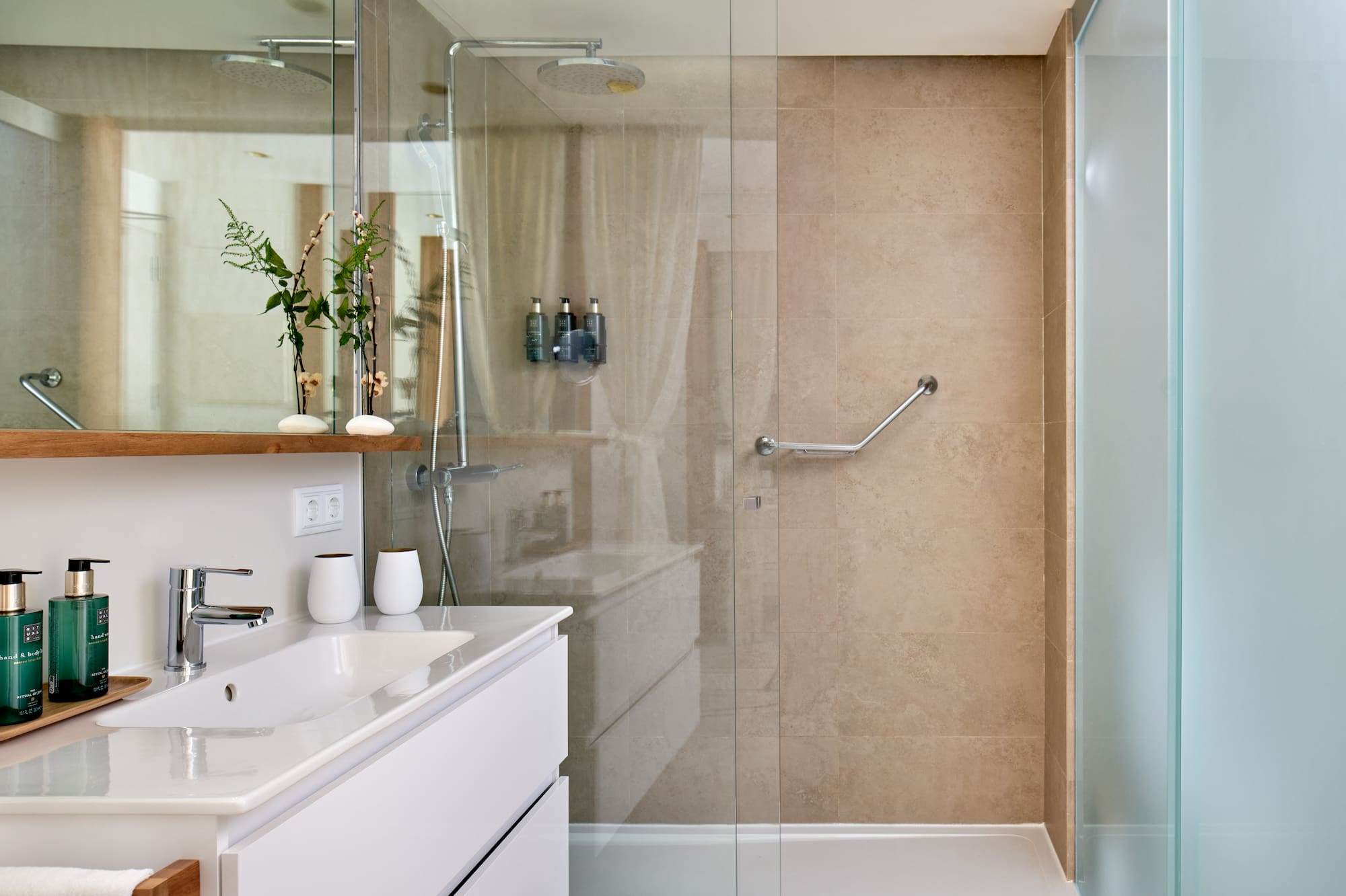 a bathroom with a glass shower door