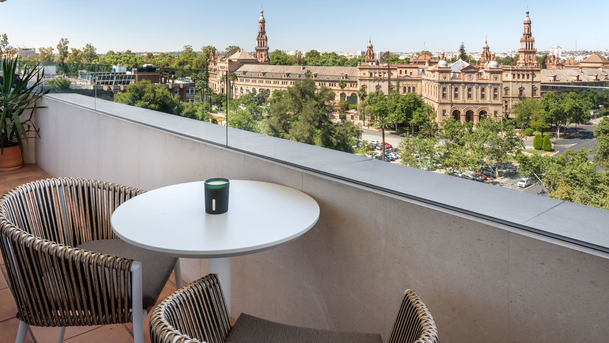 a table and chairs on a balcony overlooking a city
