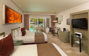 a room with two beds and a television