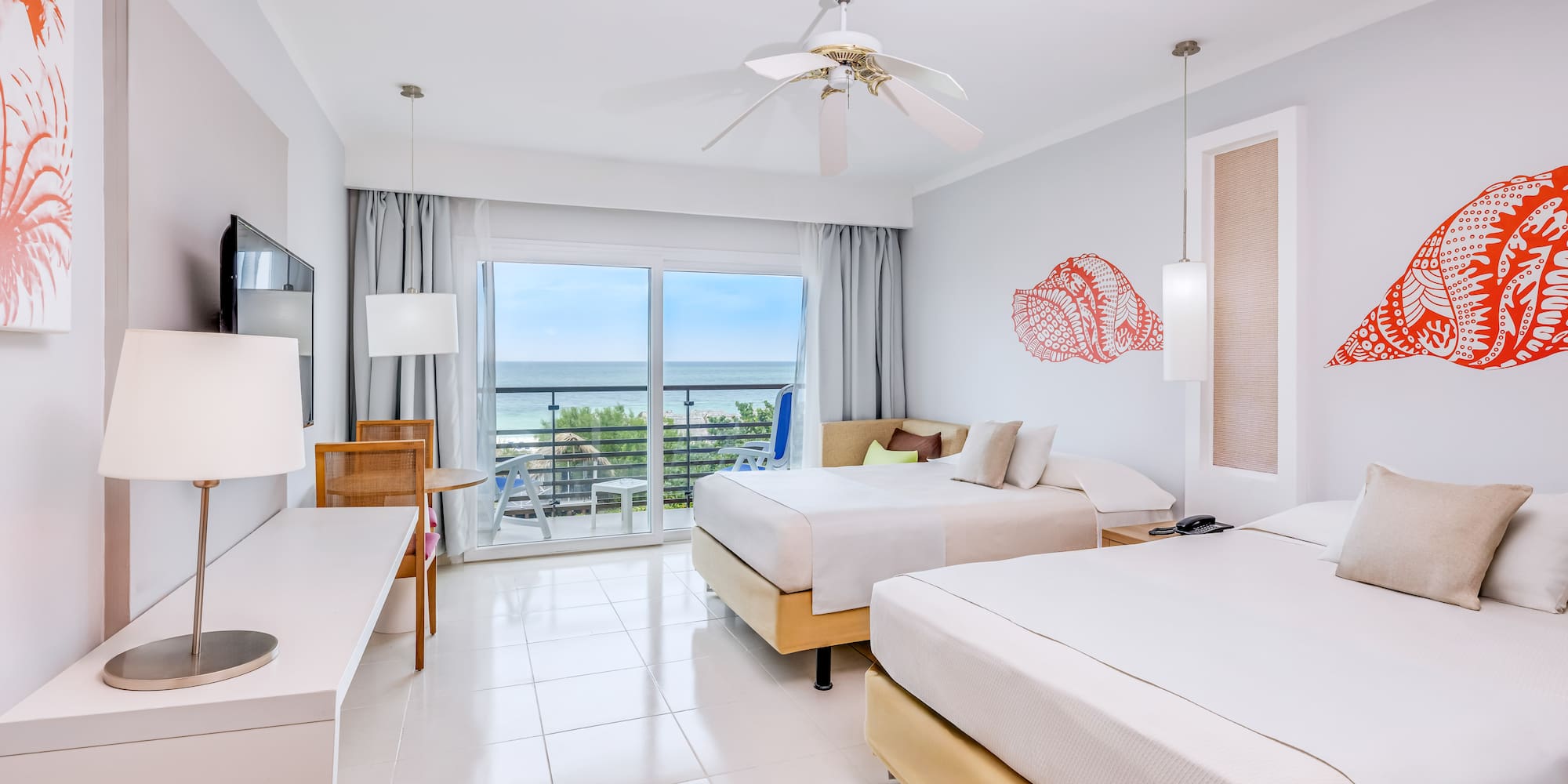 a room with two beds and a ceiling fan