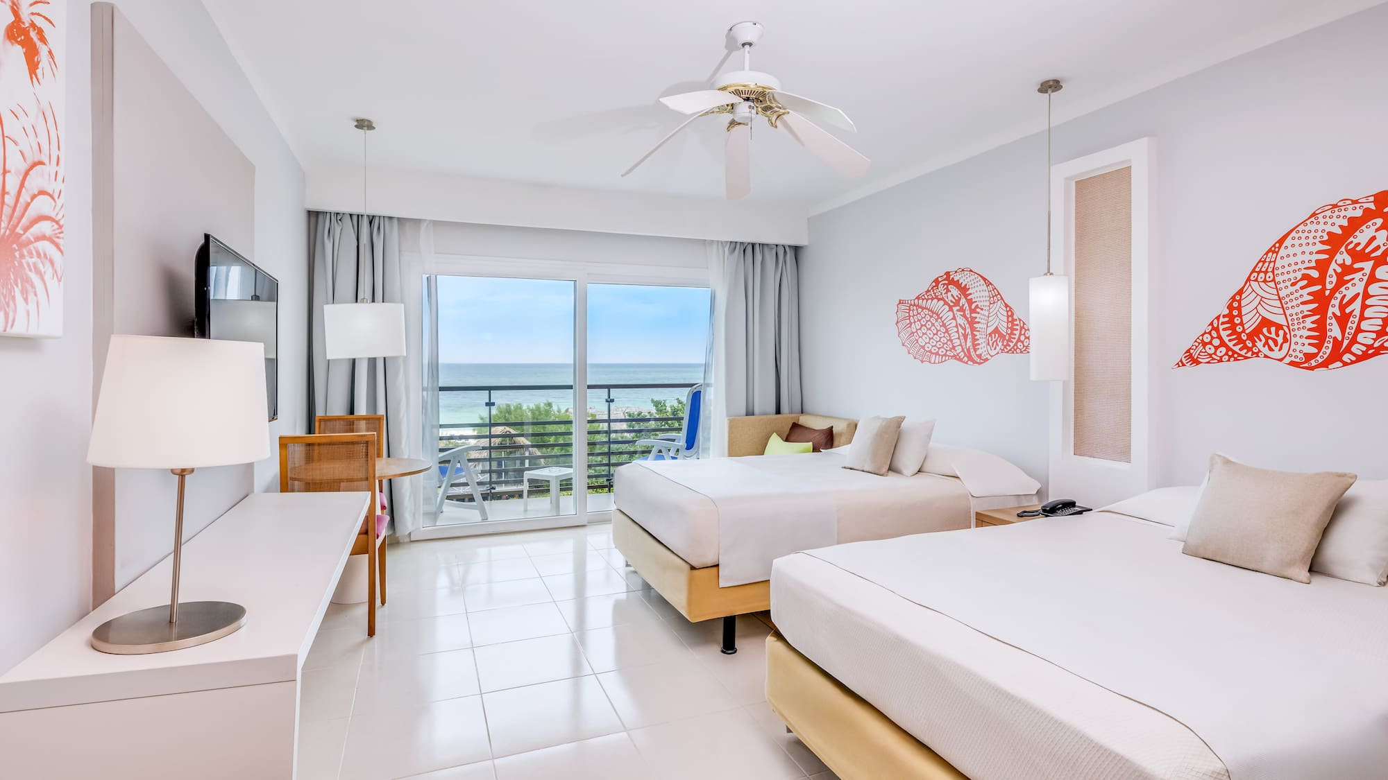 a room with two beds and a ceiling fan