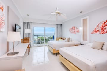 a room with two beds and a ceiling fan