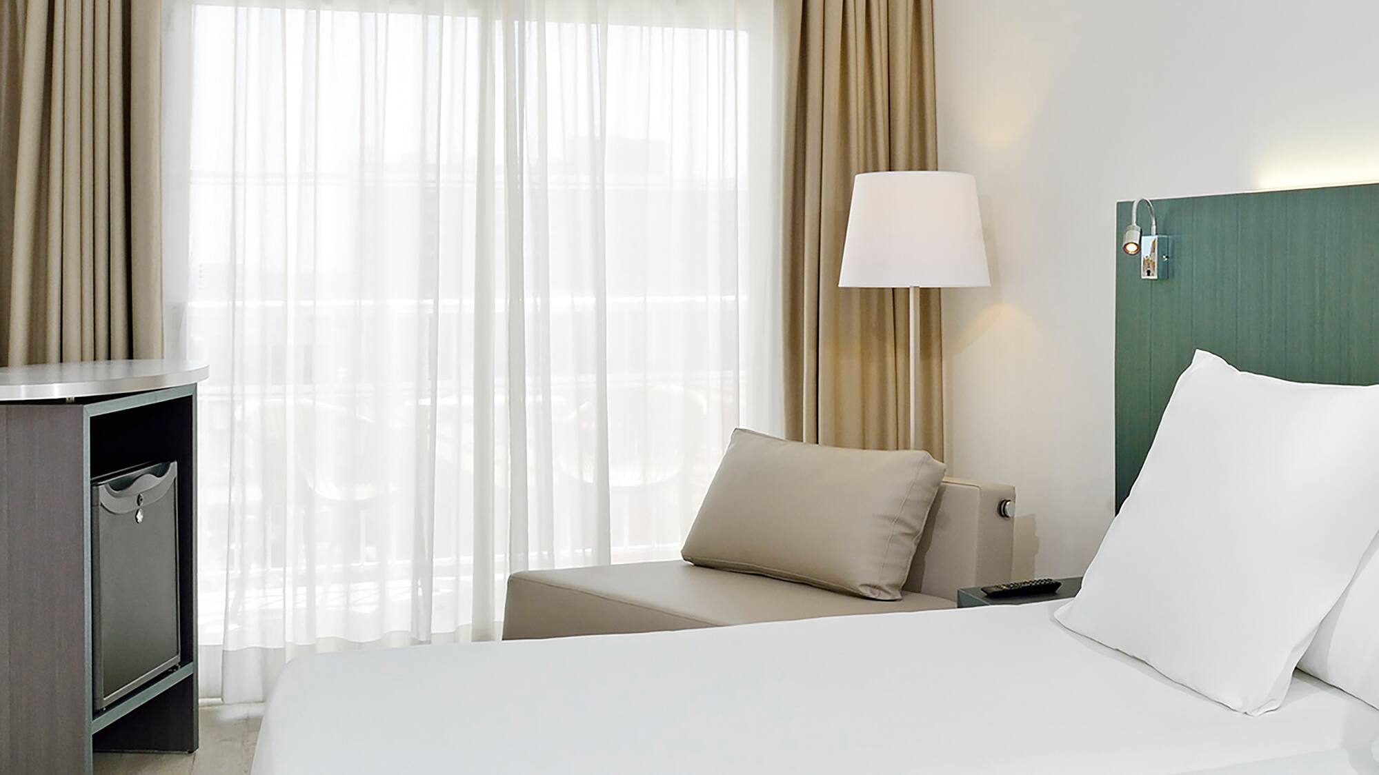 a room with two beds and a table