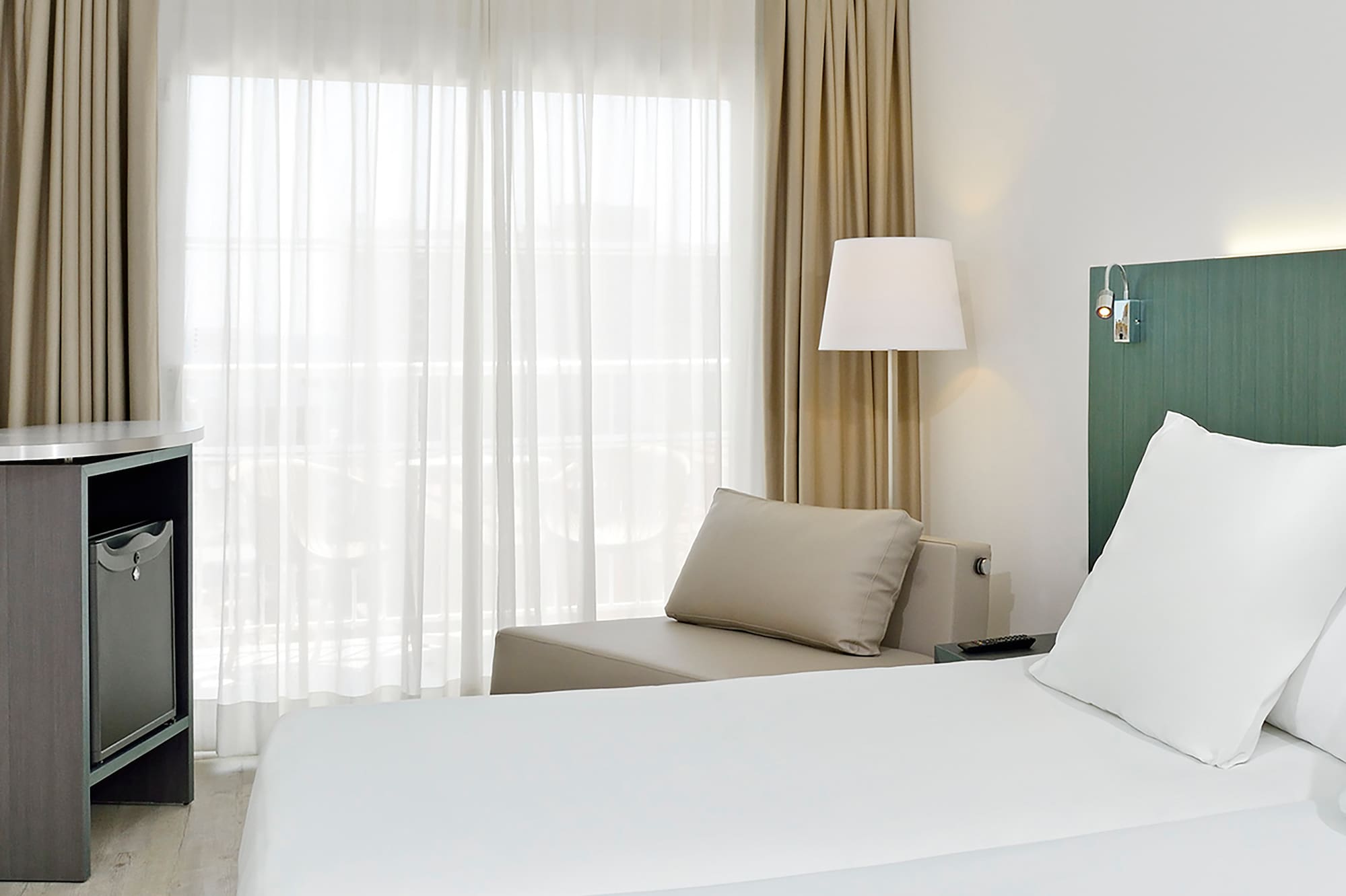 a room with two beds and a table