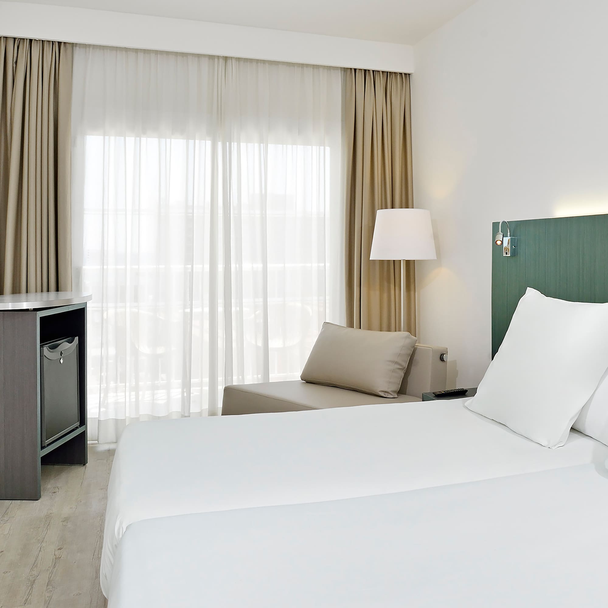 a room with two beds and a table