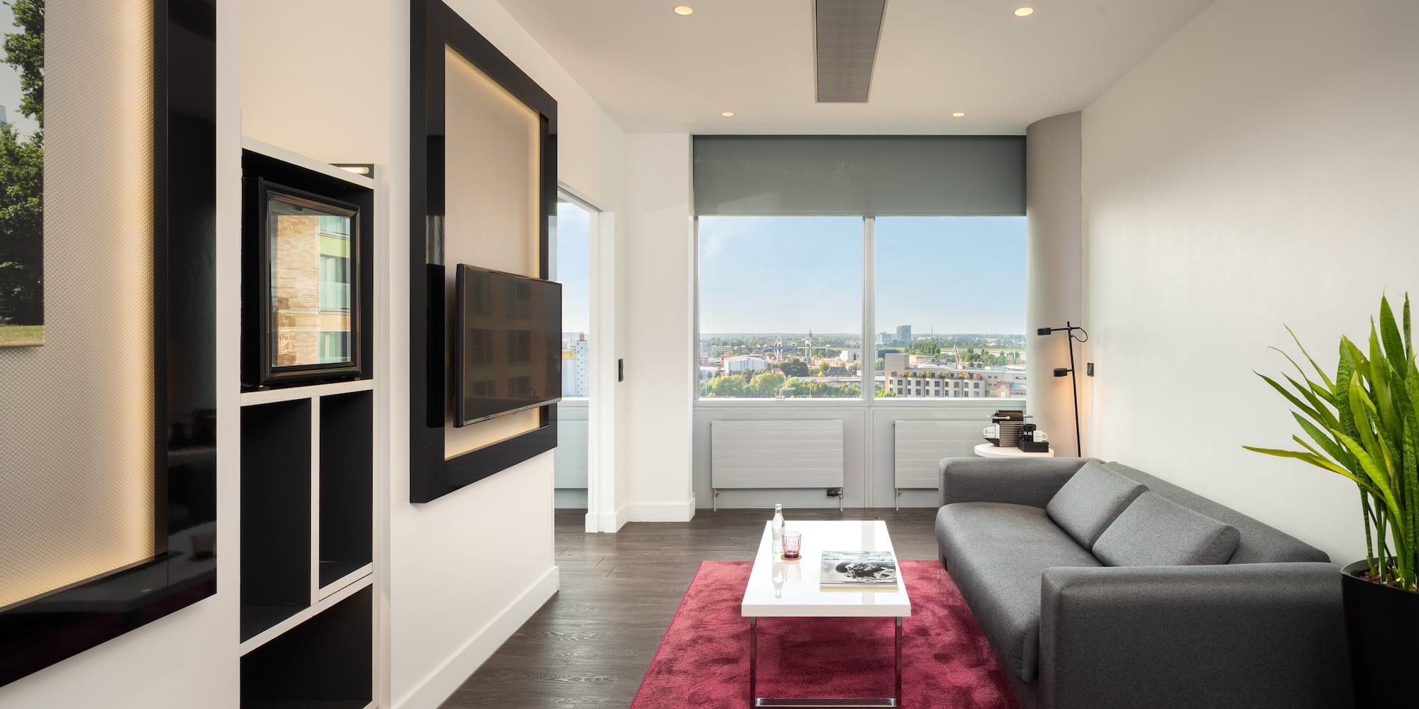 a living room with a couch and a red rug