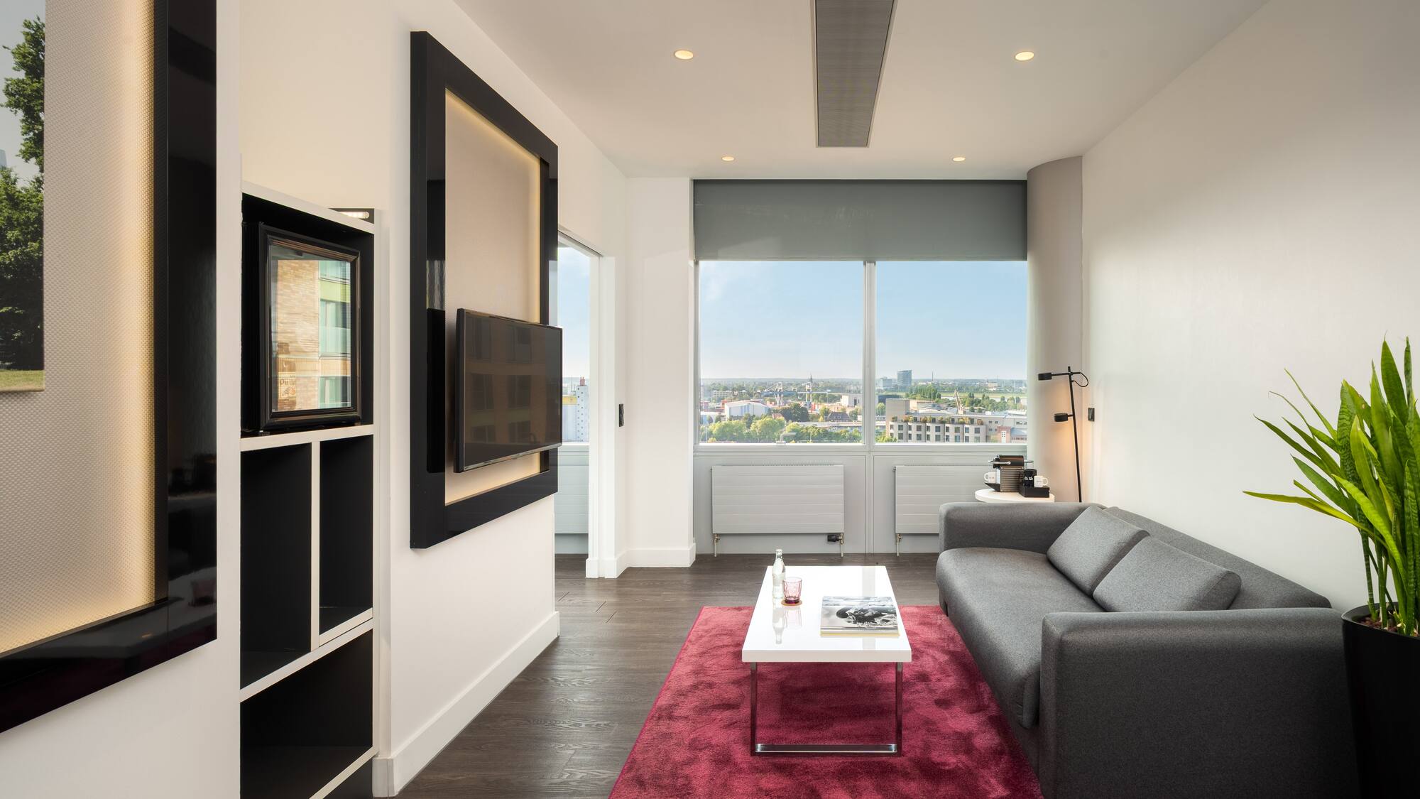 a living room with a couch and a red rug