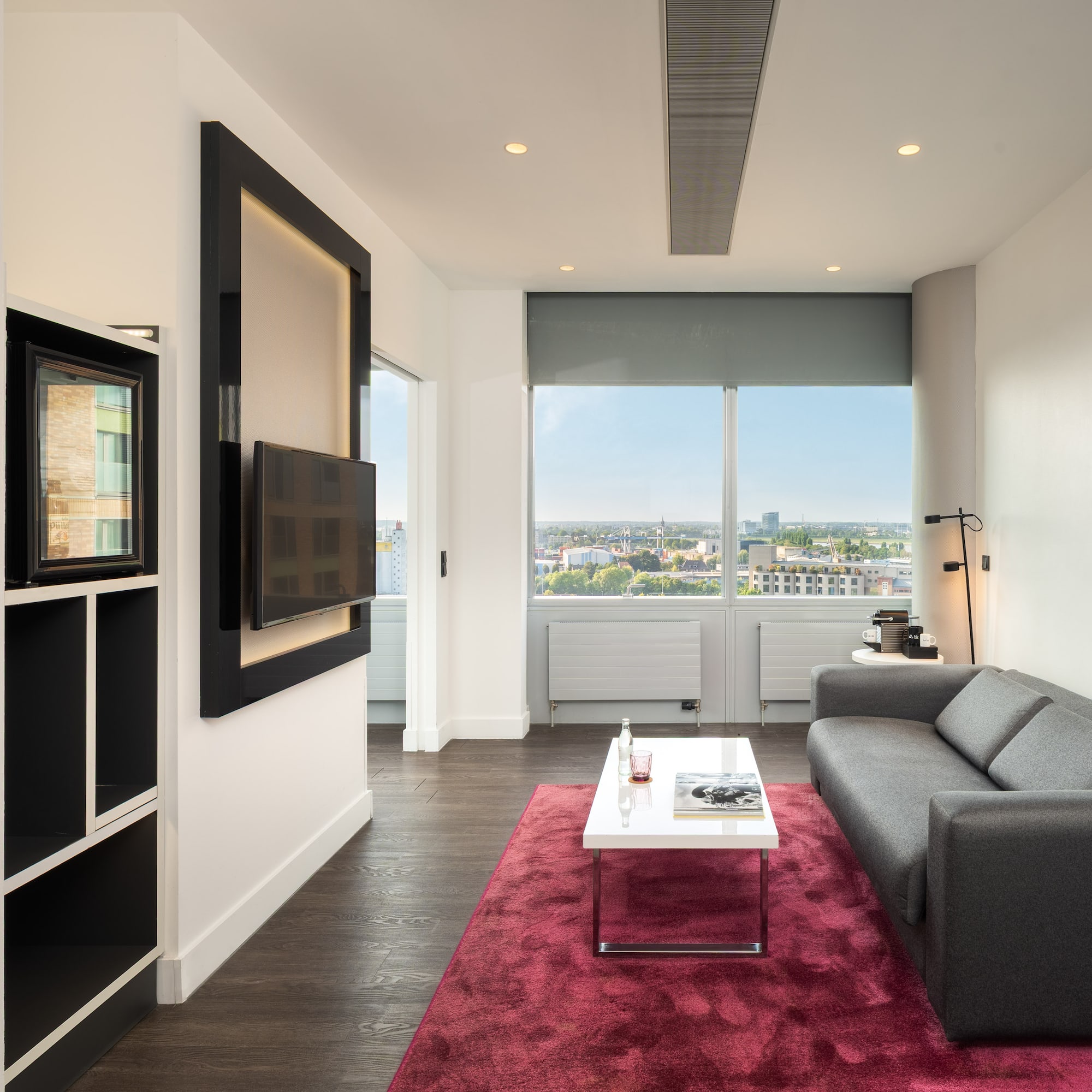 a living room with a couch and a red rug
