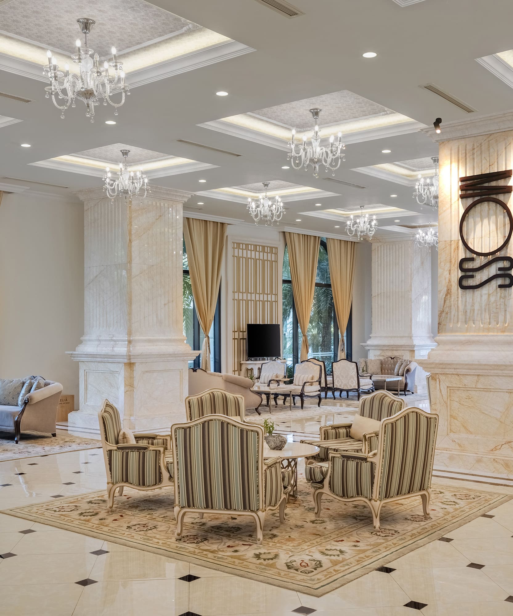 a room with a large chandelier and chairs