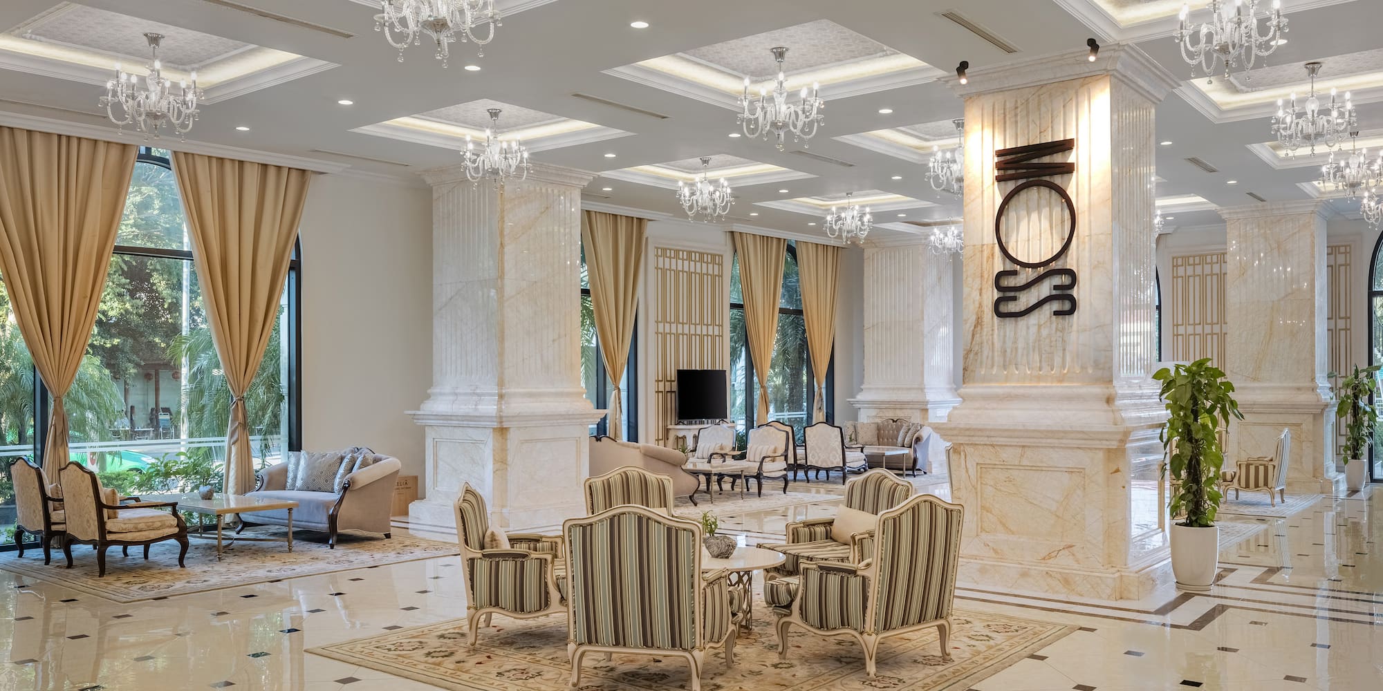 a room with a large chandelier and chairs