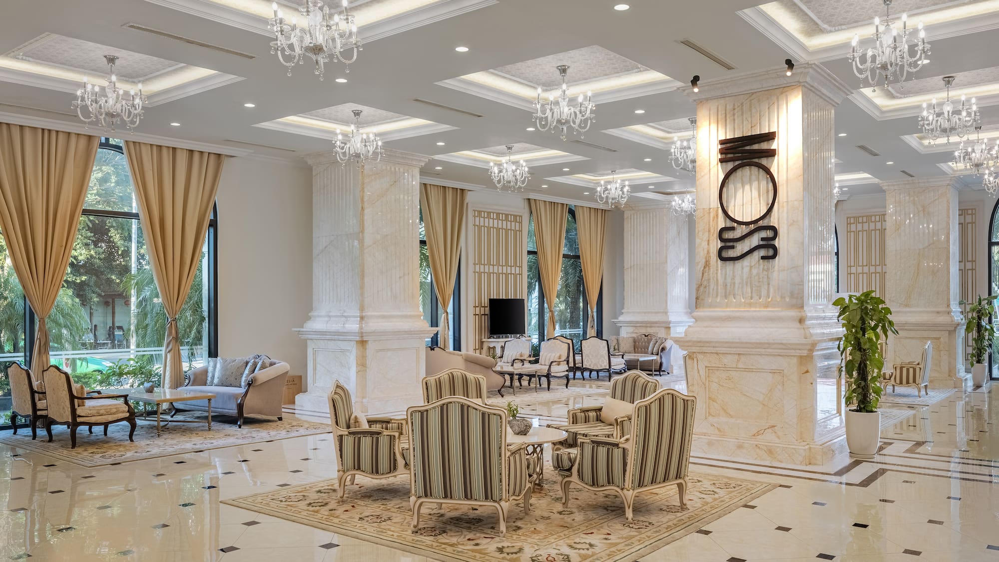 a room with a large chandelier and chairs