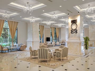 a room with a large chandelier and chairs