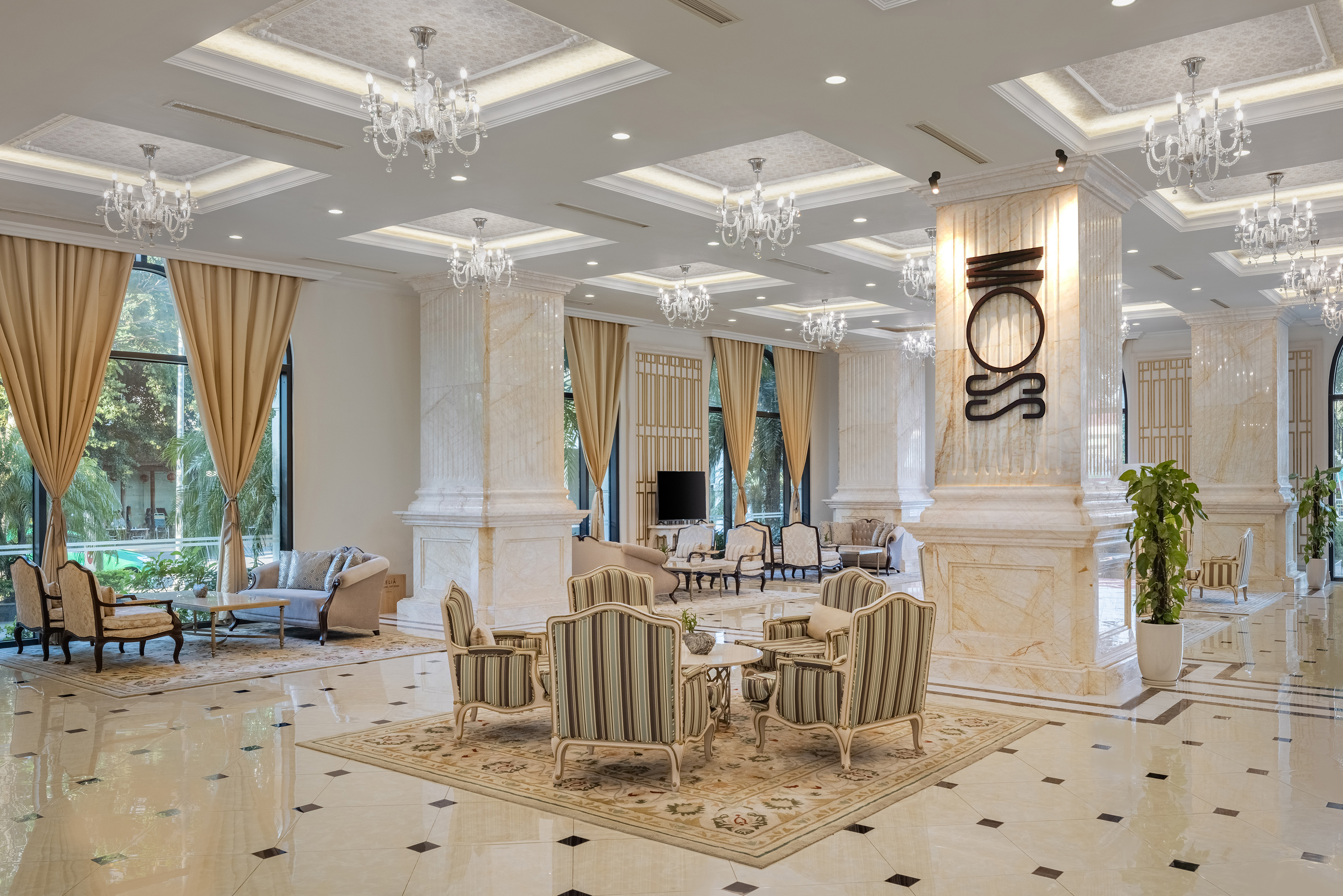 Elegant hotel lobby, marble columns, luxury chandeliers, and plush seating.