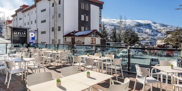 a restaurant with tables and chairs on a rooftop