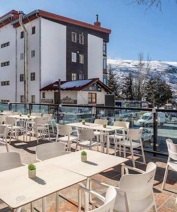 a restaurant with tables and chairs on a rooftop