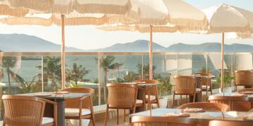 a table and chairs with umbrellas