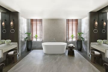 a bathroom with a tub and plants