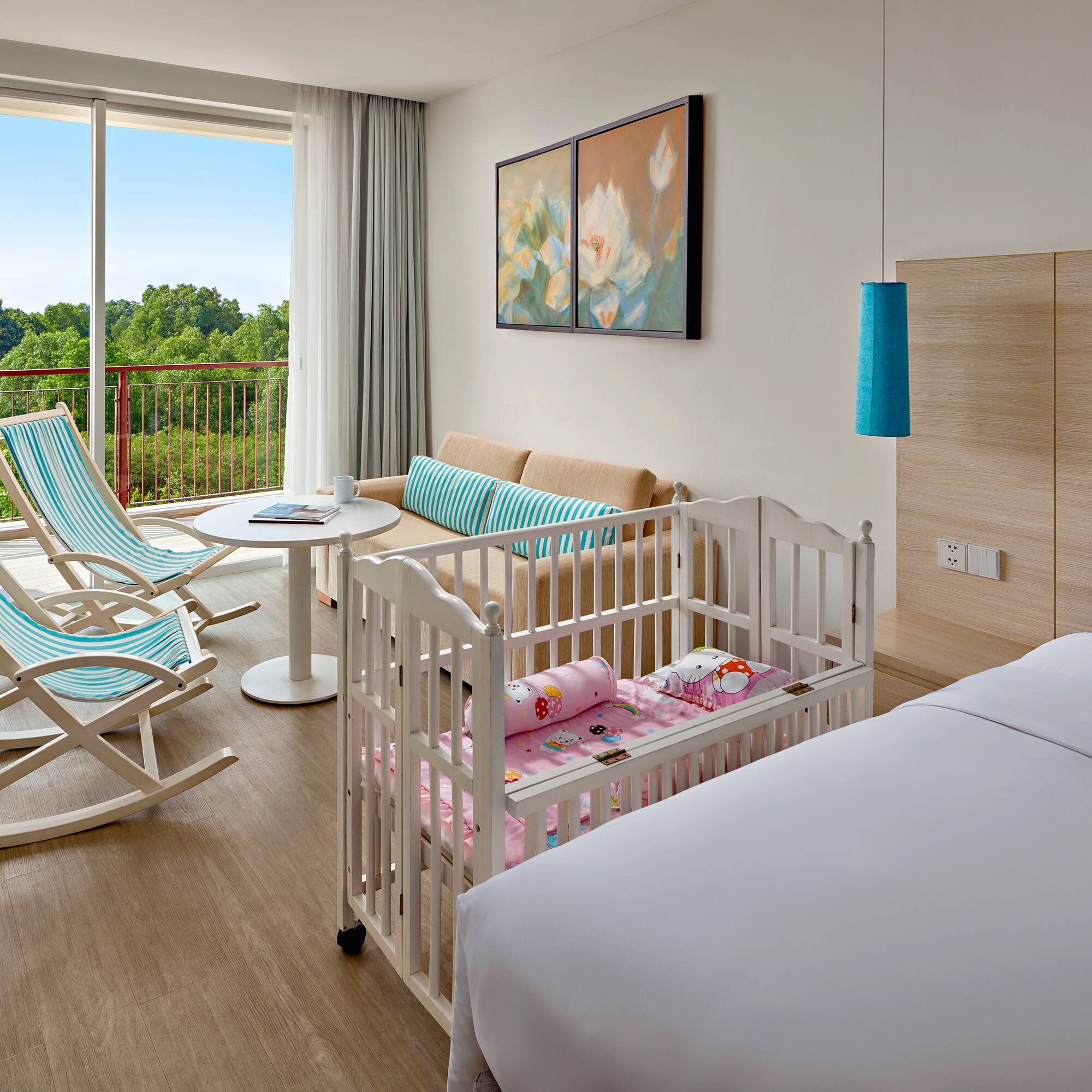 a room with cribs and chairs