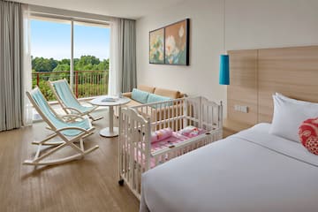 a room with cribs and chairs