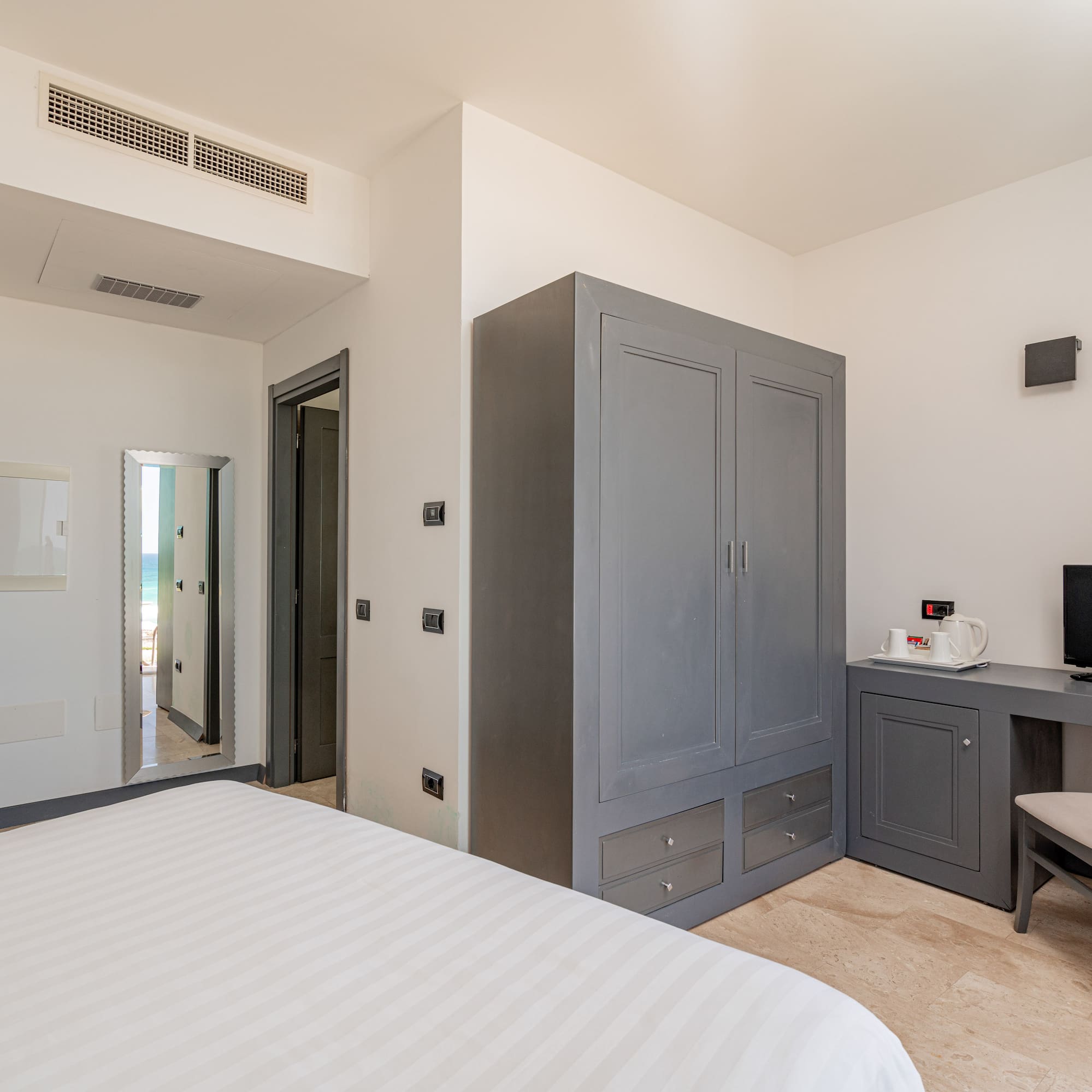 a bedroom with a bed and a desk