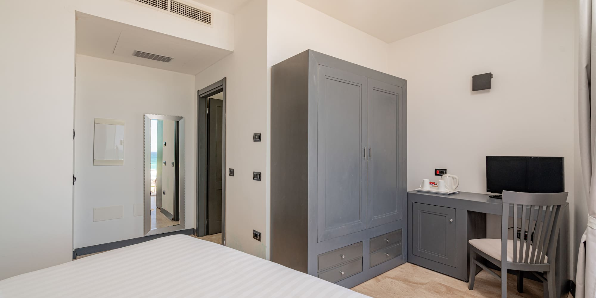 a bedroom with a bed and a desk