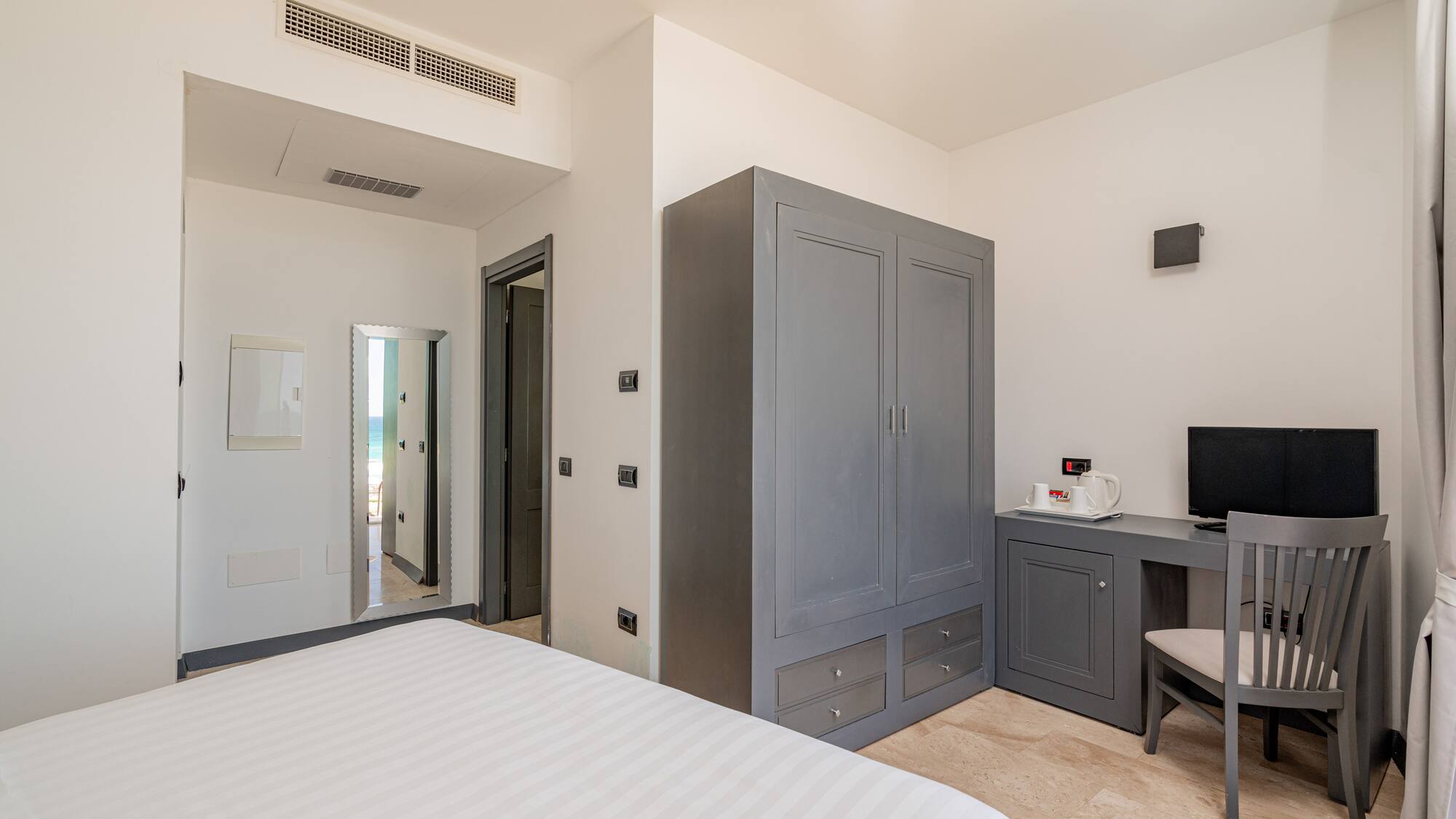 a bedroom with a bed and a desk