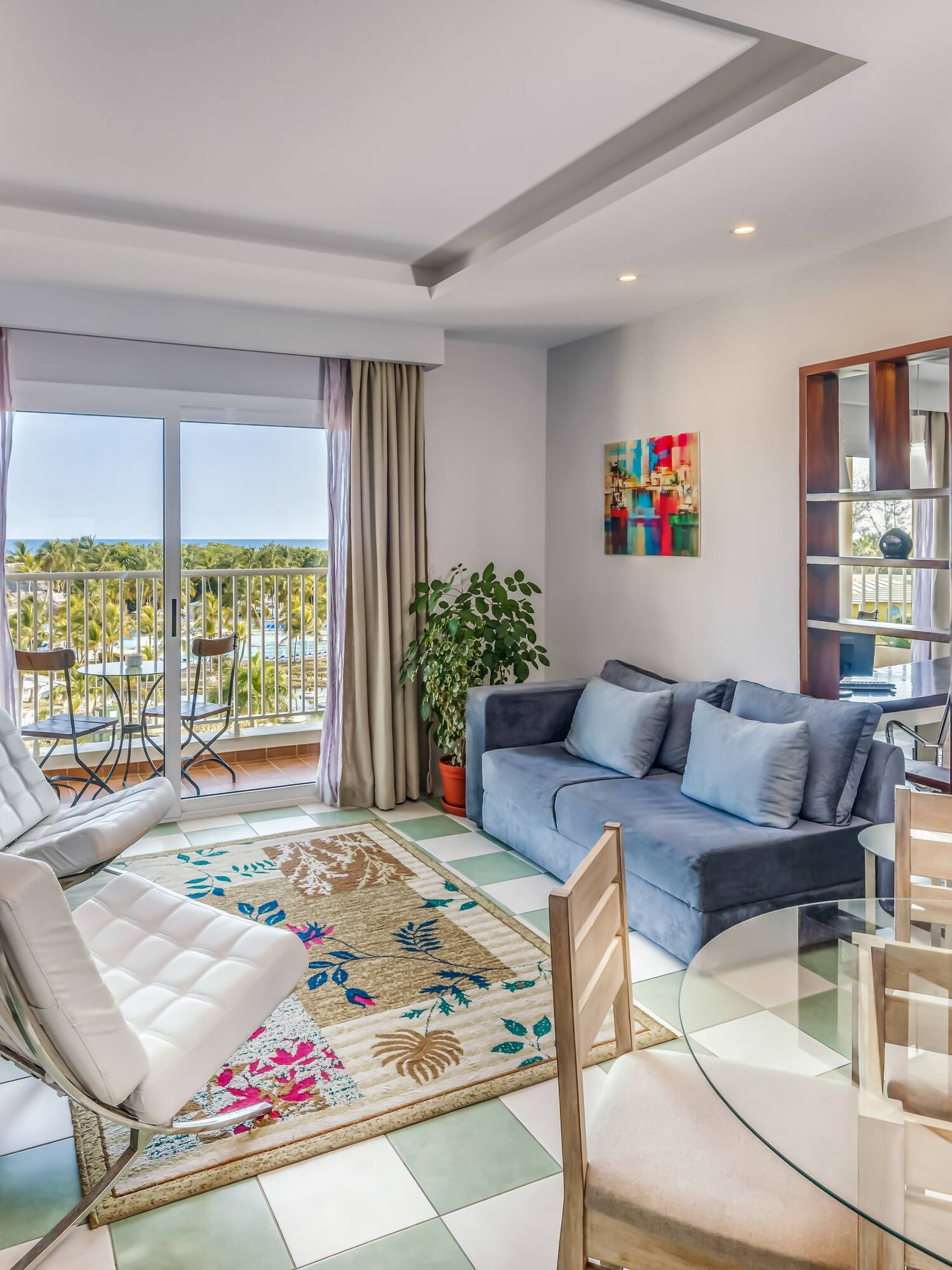 a living room with a glass table and chairs