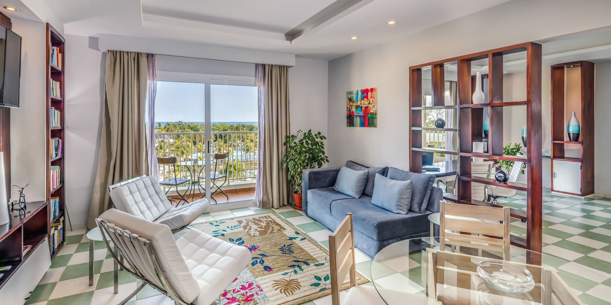 a living room with a glass table and chairs