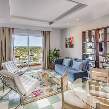 a living room with a glass table and chairs