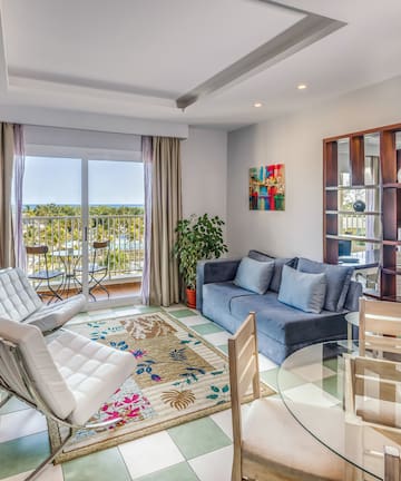 a living room with a glass table and chairs