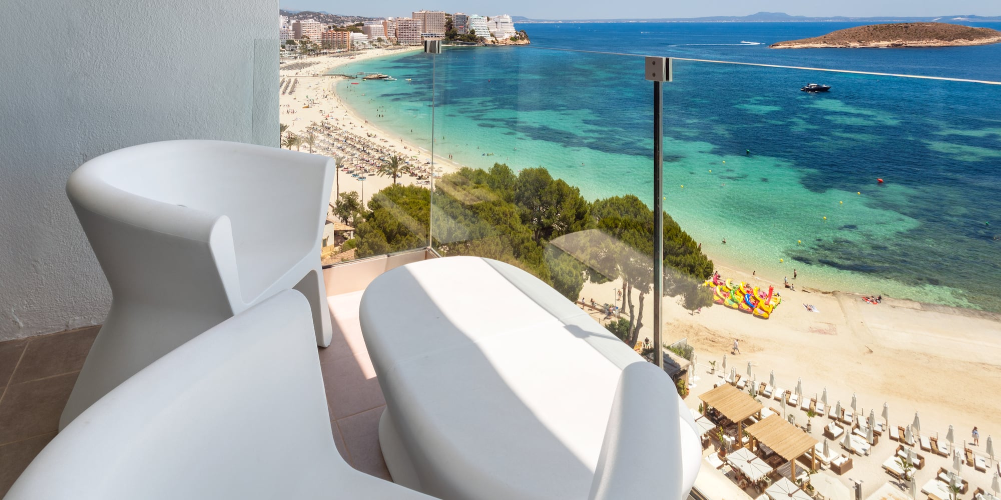 a balcony with a view of a beach and a city