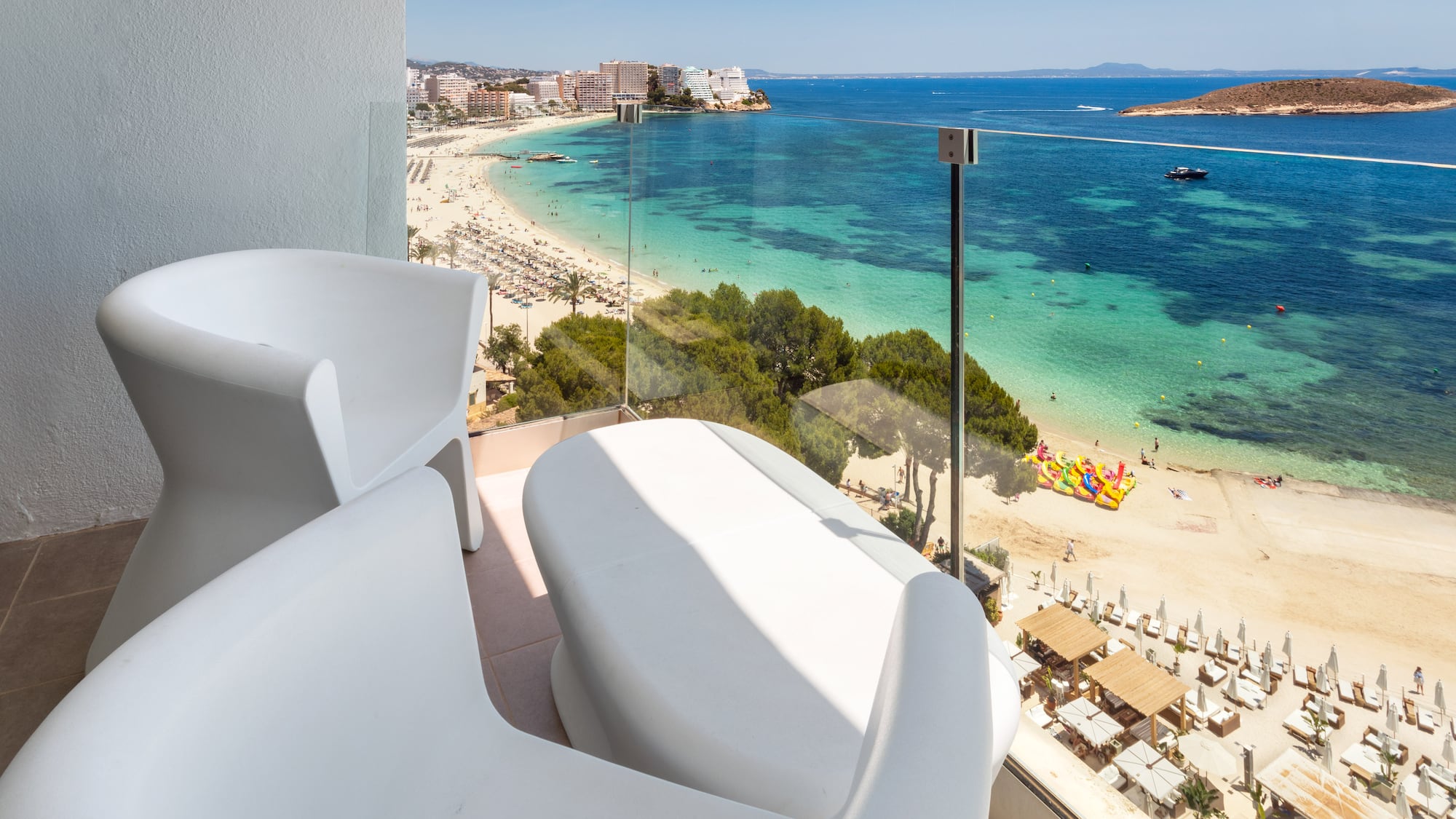 a balcony with a view of a beach and a city