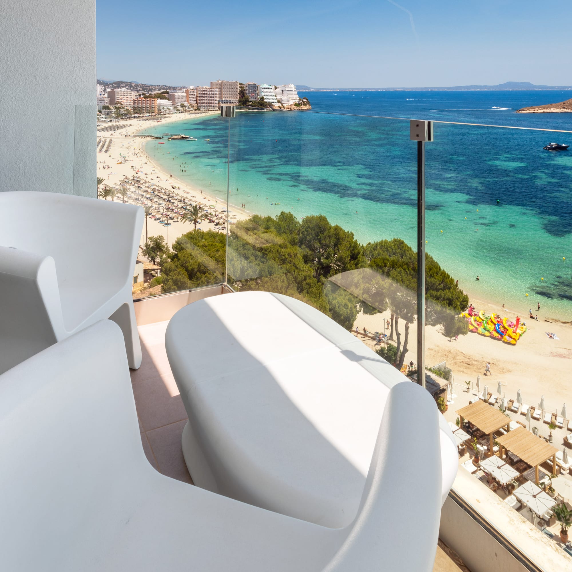 a balcony with a view of a beach and a city