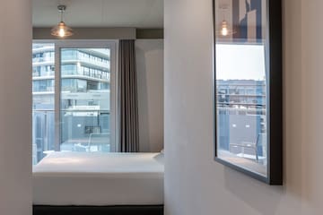 a bedroom with a bed and a window