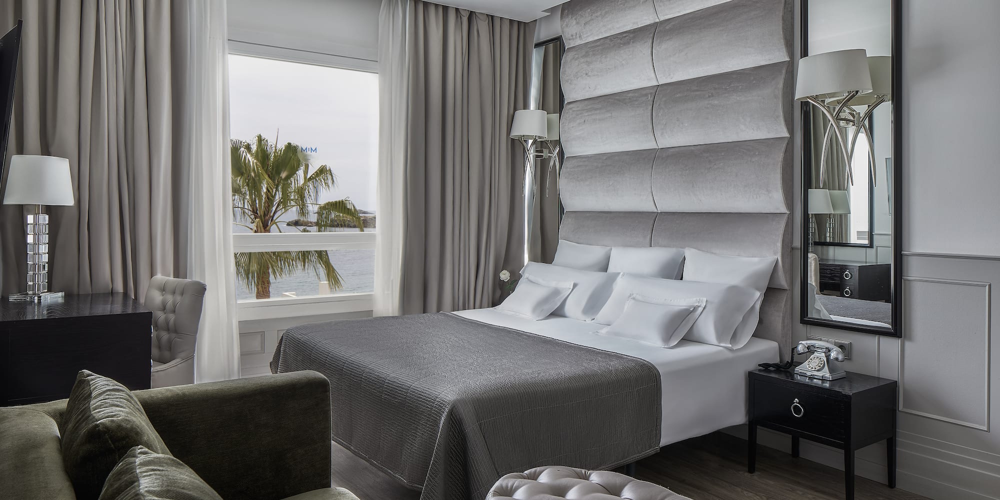 a room with a large bed and a large mirror