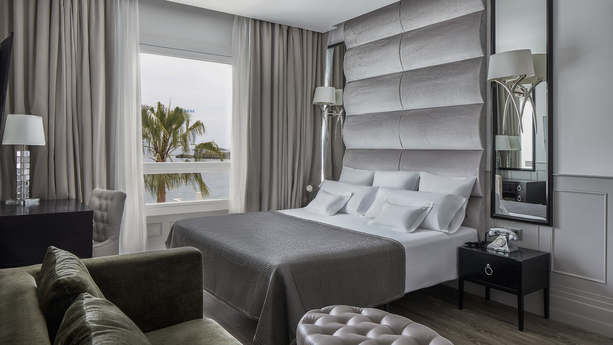 a room with a large bed and a large mirror