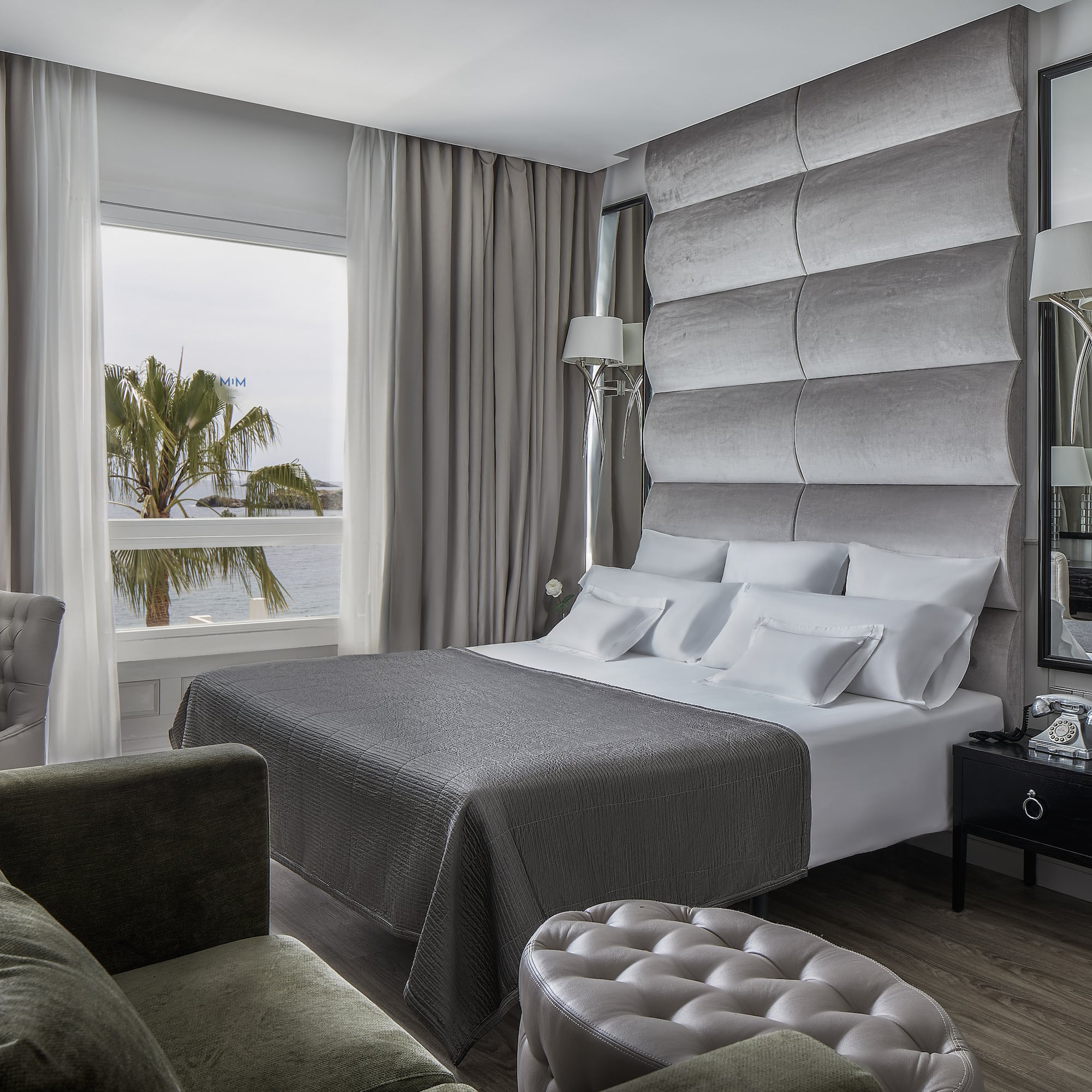 a room with a large bed and a large mirror