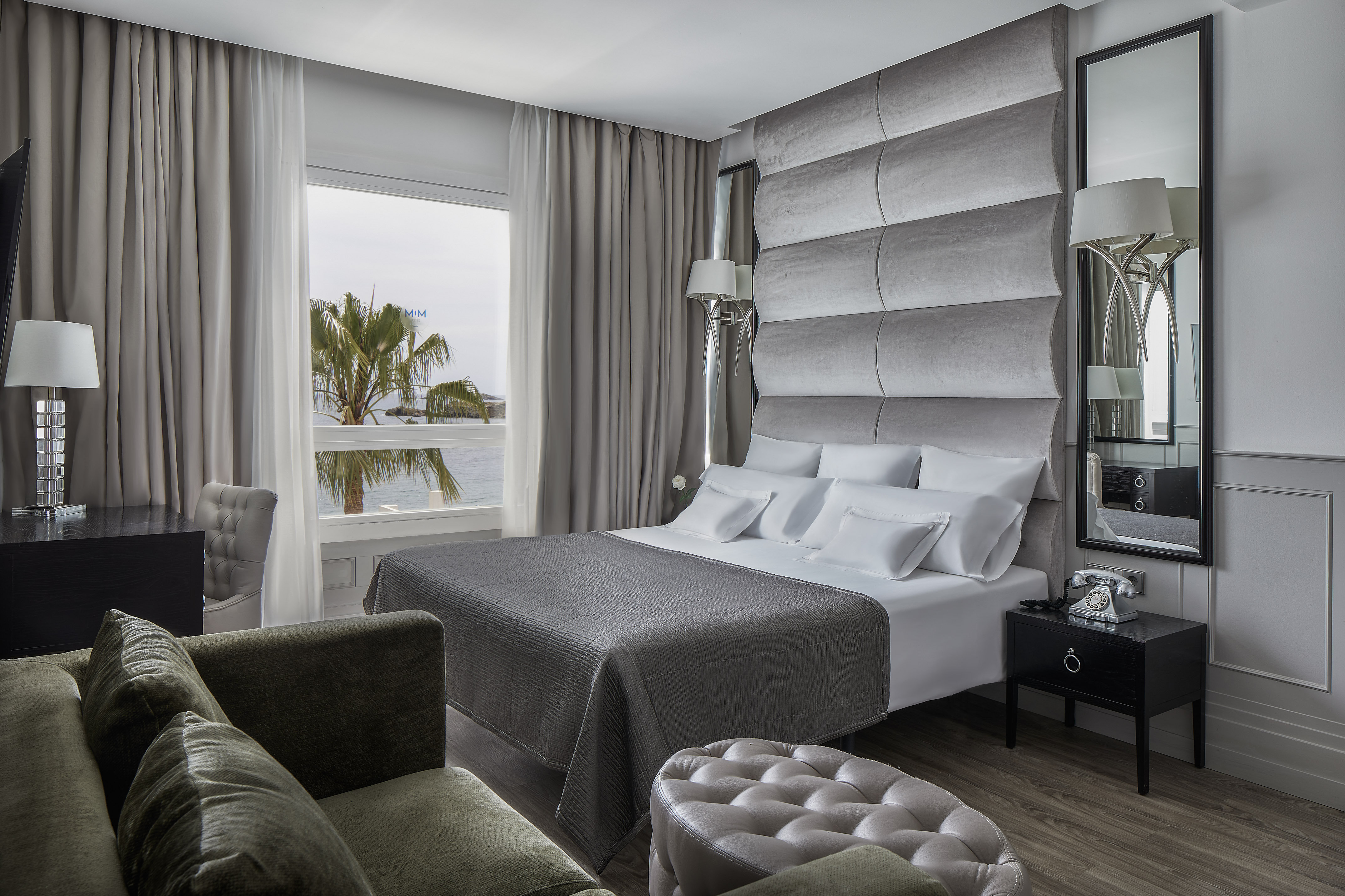 a room with a large bed and a large mirror