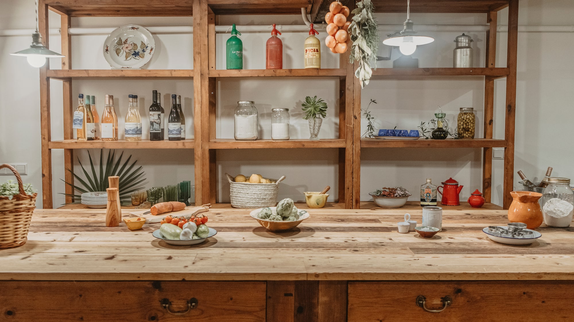 a kitchen with shelves and food on the counter