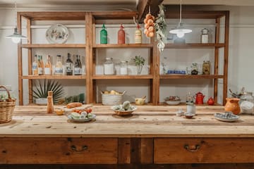 a kitchen with shelves and food on the counter