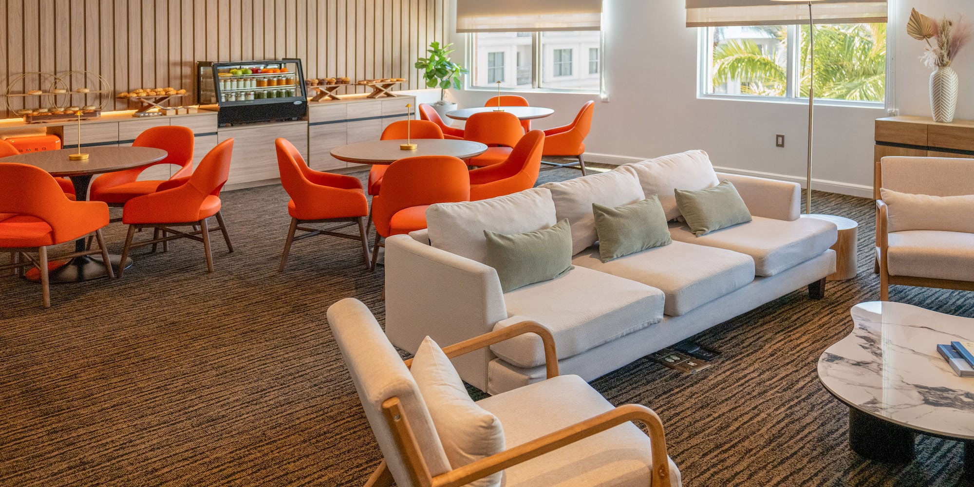 a room with a couch and chairs