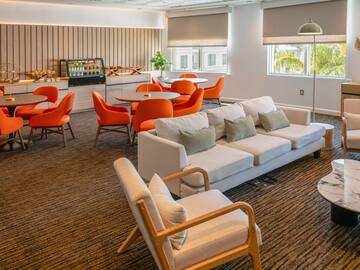 a room with a couch and chairs