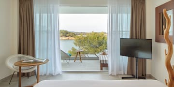 a room with a television and a view of the water