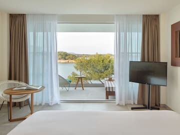 a room with a television and a view of the water