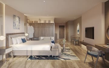 a room with a bed and a tv