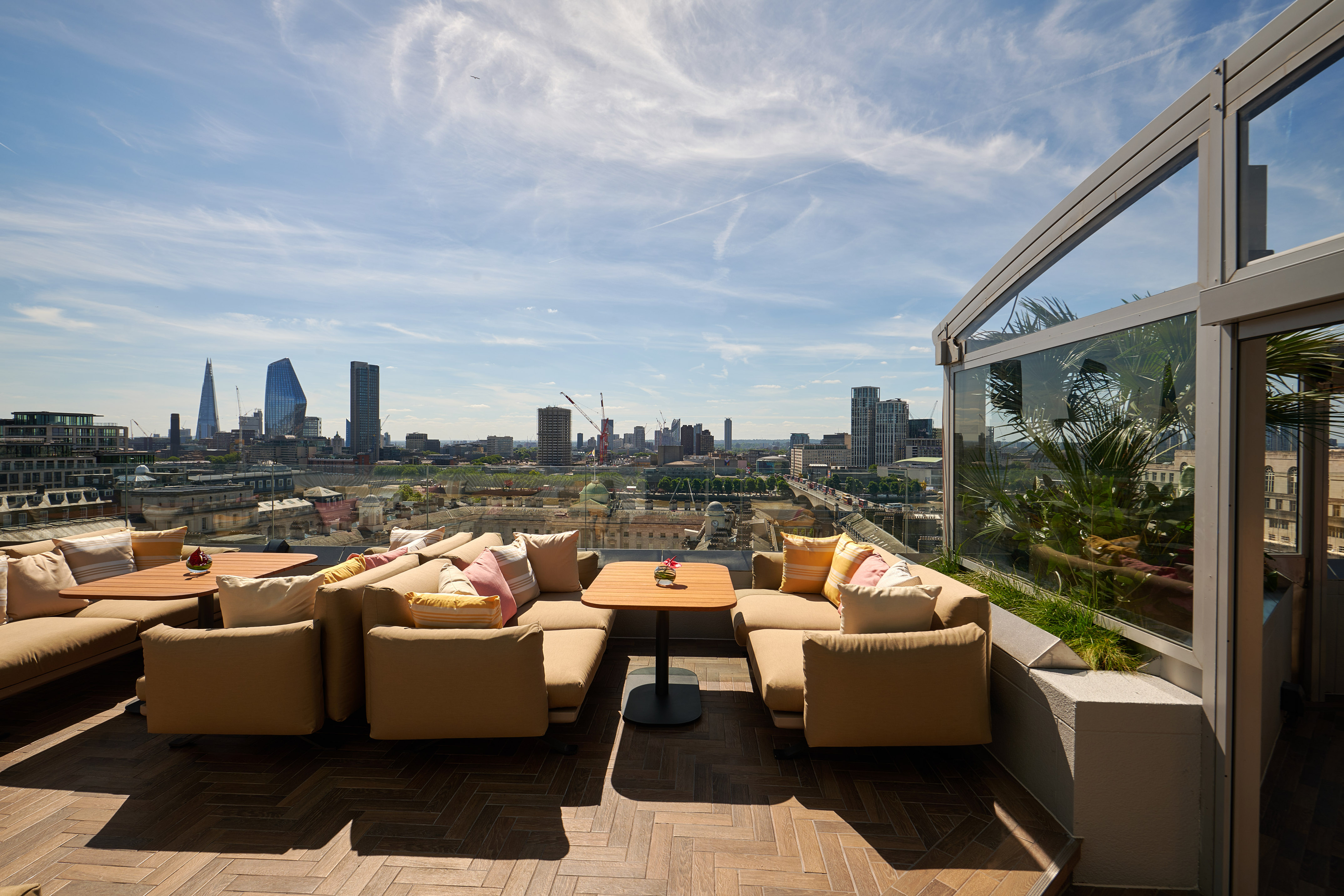 a rooftop patio with a city view